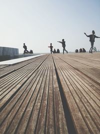 Men against clear sky