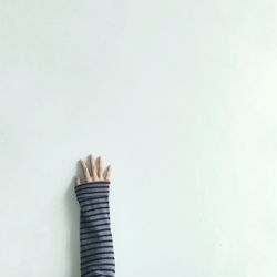 Close-up of hand over white background