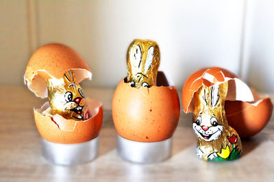 Close-up of easter bunnies with egg shells on table