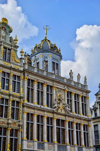 Low angle view of building against cloudy sky
