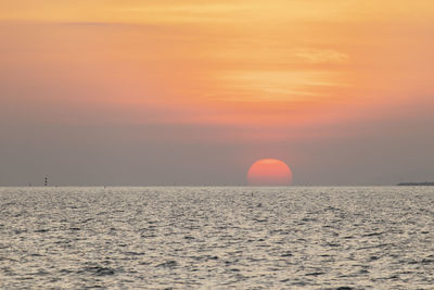 Scenic view of sea against romantic sky at sunset