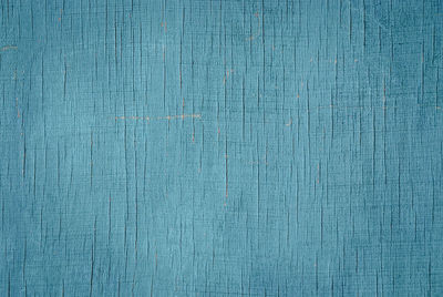 Blue wooden texture, shabby faded painted plywood cracks scratches and stains, retro background