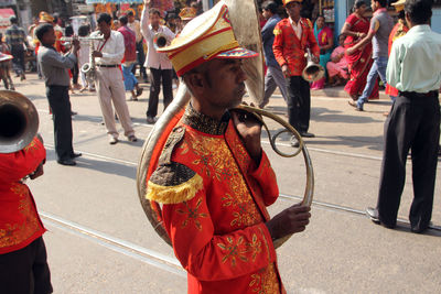 Side view of musician during procession at street