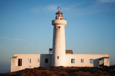 Low angle view of lighthouse against blue sky