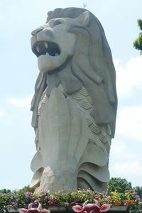 Low angle view of statue against cloudy sky