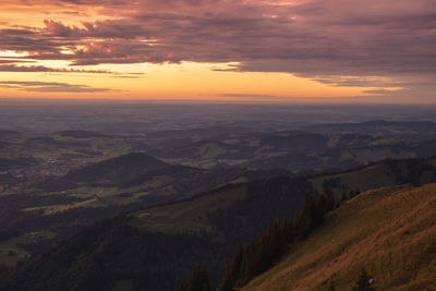 Scenic view of dramatic landscape against sky during sunset