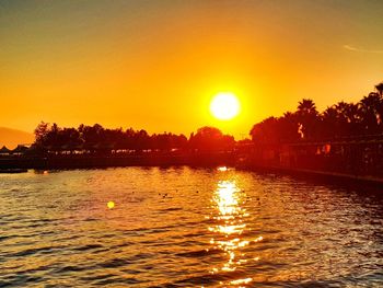 Scenic view of lake against sky during sunset