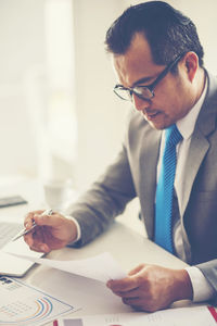 Businessman working at table in office