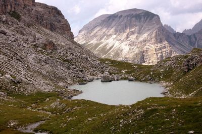 Scenic view of lake by mountains against sky