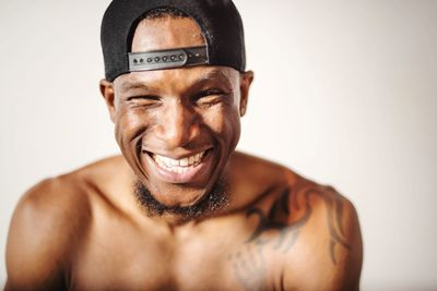 Portrait of shirtless smiling young man