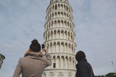 Rear view of women against leaning tower of pisa
