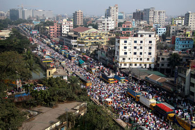 High angle view of buildings and people in city