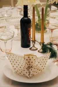 High angle view of napkin in plate with wineglasses on table