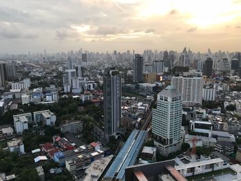 High angle view of modern buildings against sky during sunset