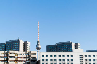 Buildings in city against blue sky