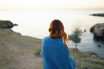 Rear view of woman looking at sea