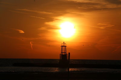 Scenic view of sea against orange sky