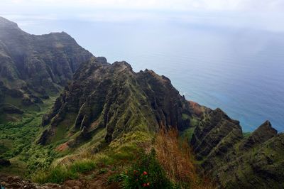 High angle view of sea and hawaiian mountains against sky