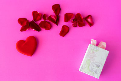 High angle view of heart shape against pink background