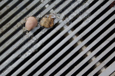 High angle view of stones on sewer