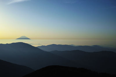 Scenic view of silhouette mountains against sky during sunset