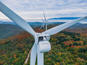 Close-up on the propellers of a wind turbine during a misty morning and sunrise. green energy. 