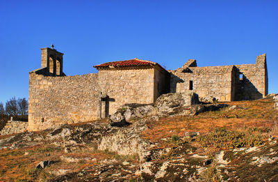 Old building against clear blue sky