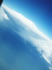 Scenic view of mountains against blue sky