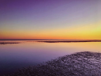 Scenic view of sea against clear sky during sunset