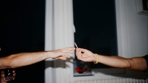 Midsection of couple holding hands