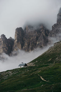 Hiking through the fog in drei zinnen nature park, south tyrol, italy