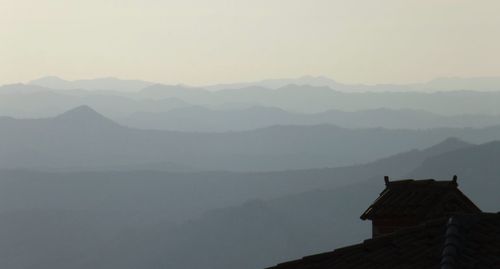 Scenic view of mountains in foggy weather