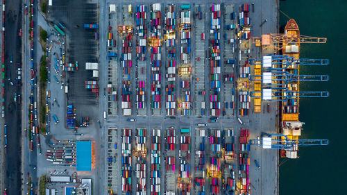 Aerial view container ship loaded in container terminal at night, global business import export 