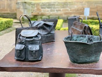 Close-up of old objects on table against wall