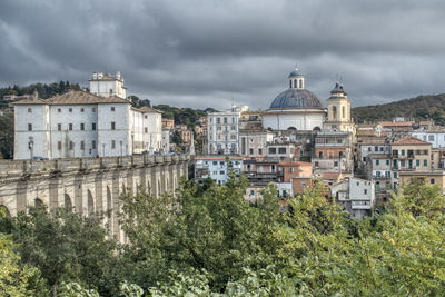 Buildings against cloudy sky