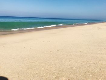 Scenic view of beach against clear sky