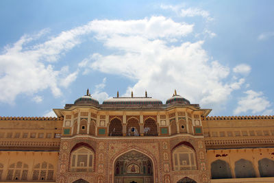 Low angle view of historical building against cloudy sky