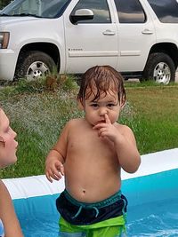 Rear view of shirtless boy in swimming pool