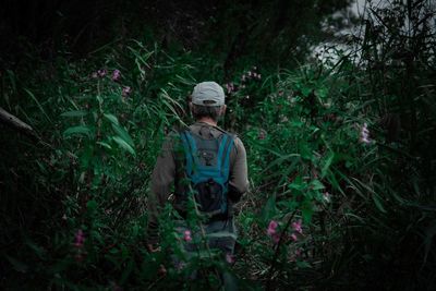 Man standing on field in forest
