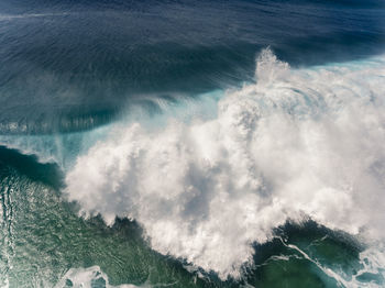 High angle view of waves splashing in sea