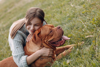 Young woman with dog on field