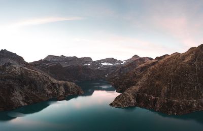 Scenic view of lake and mountains against sky