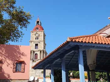 Low angle view of building against clear blue sky