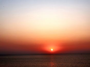 Scenic view of sea against orange sky