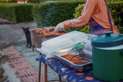 Man working on barbecue grill