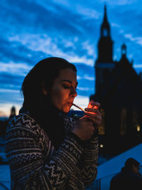 Woman standing against sky during winter