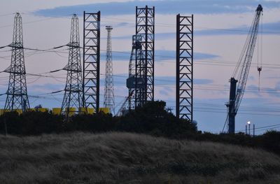 Low angle view of electricity pylon against sky