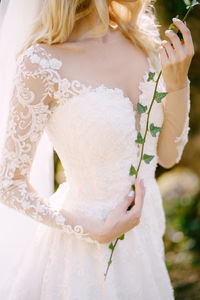 Midsection of woman holding bouquet