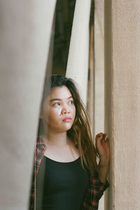 Beautiful young woman looking away outdoors