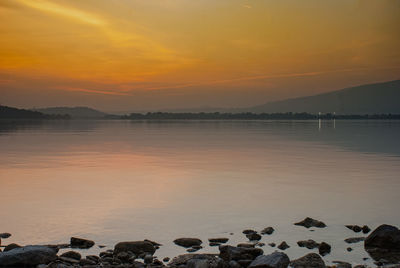 Scenic view of beach against sky during sunset